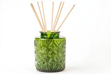 Green decorative jar with bamboo sticks for fragrance placed on a simple background in a bright indoor setting during daylight hours