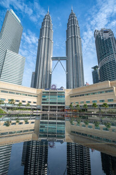 Petronas Towers, which is Kuala Lumpur City Centre (KLCC), with water reflection in the foreground.