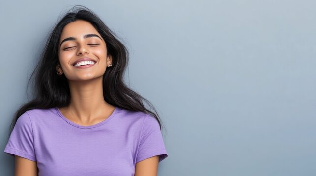 Woman with closed eyes, smiling, exuding serenity and happiness, peaceful.