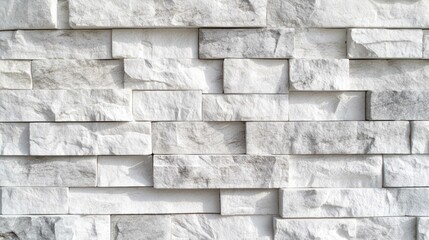 Fototapeta premium A textured stone wall, with a neutral grey-white palette, stack block pattern.