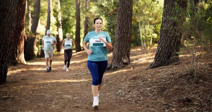 People, running or forest with finish for marathon challenge, race or endurance sprint in nature. Mature, team or runner with group for sport event, jogging competition or outdoor fitness together