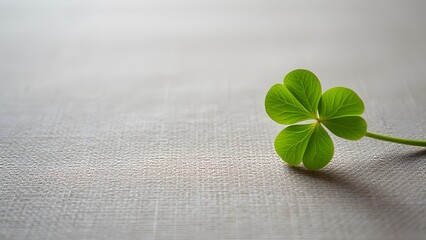 Vibrant Green Clover Leaf on Light Grey Wood Background