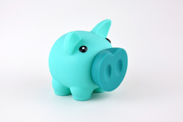 Blue piggy bank on white table.