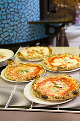 Freshly baked Neapolitan pizzas on plates