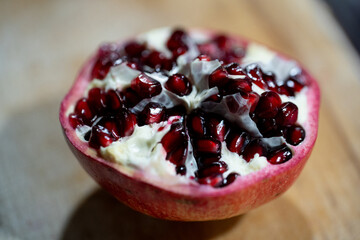 Freshly cut pomegranate featuring its juicy seeds, perfect for any meal or dessert choice