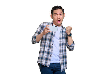 Fototapeta premium Excited young Asian man in plaid shirt celebrating success with a mobile phone, raising hands rejoiced big luck isolated on transparent background
