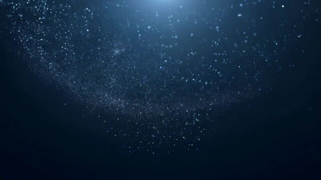 A mesmerizing display of glittering stars emerging from a dark blue background. The cosmic particles create an enchanting and serene atmosphere, perfect for artistic projects.