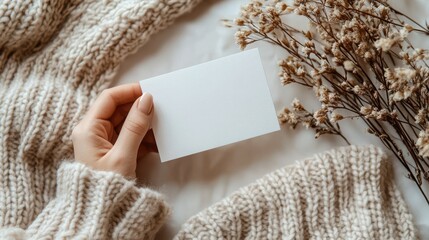 Blank White Card Mockup with Beige Knitwear and Dried Flowers