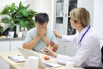 Fototapeta premium Doctor comforts distressed patient in medical office, showing empathy and support