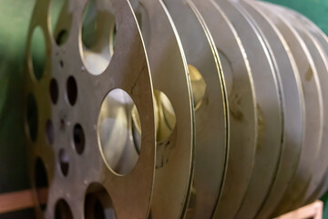 Vintage film reels stacked on a shelf in a dimly lit room