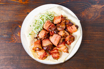 Savory bacon-wrapped chicken bites served on a plate