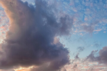 Blue sky fluffy clouds. Cloudy evening sunlight. Sunset in Santa Cruz de Tenerife, Spain
