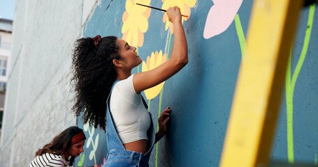 People, wall painting and women with volunteering, design and teamwork for community project. Activist, artist and friends with creativity, mural and social responsibility with renovation and process