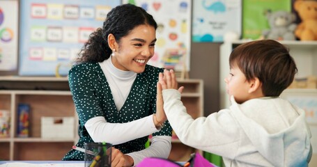 Fototapeta na wymiar Education, teacher and child with high five in classroom for learning support, assessment success and progress pride. Happy, people and celebration at academy for development, achievement and study