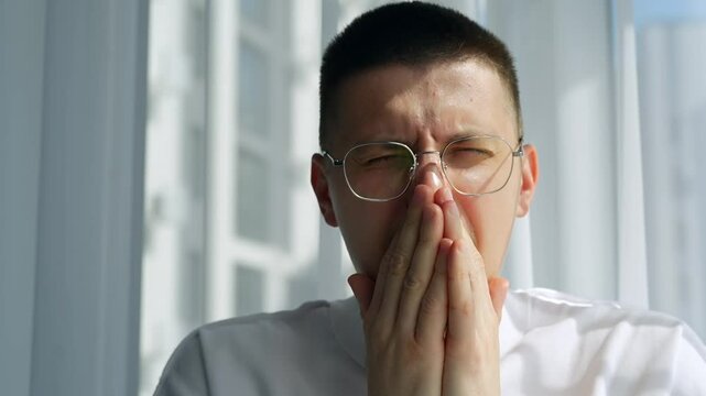 Allergy in the nose.
A man sneezes due to allergies during ragweed bloom.
Wipe and scratch the nose.
A man with allergies rubs the skin on his face in sunny weather