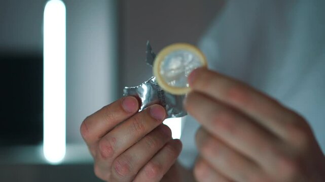 Used condom close-up in hands.
Rubber condom for sex.
Protection against unwanted pregnancy