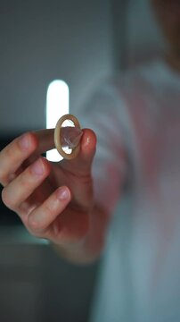 Used condom close-up in hands.
Rubber condom for sex.
Protection against unwanted pregnancy
