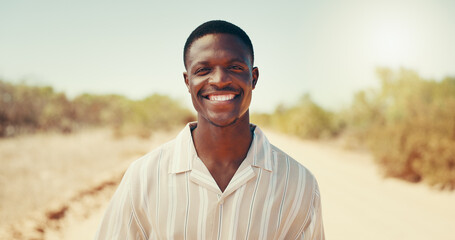 Happy, travel and portrait of black man in countryside for adventure, holiday and vacation. Smile, relax and person in nature for destination, journey or explore safari for weekend in South Africa © KayContri01/peopleimages.com