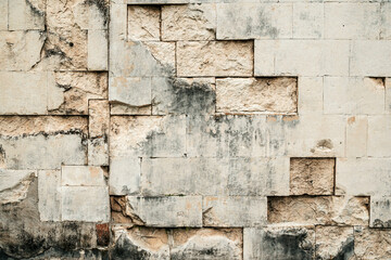 Antique ancient stone wall masonry texture background. Old wall made of beige stone blocks 