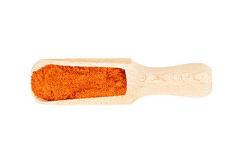 Dry spices of paprika in a wooden scoop isolated on a white background, top view