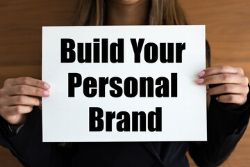Build your personal brand. Woman holds a white page, with black letters. Inspiration, influencer,...