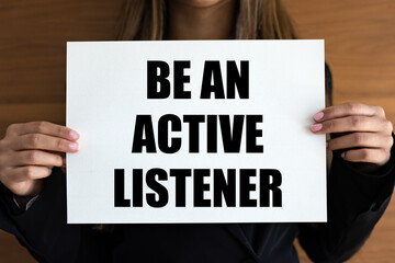 Be an active listener. Woman holds a white page, with black letters. Mindfulness, audience,...
