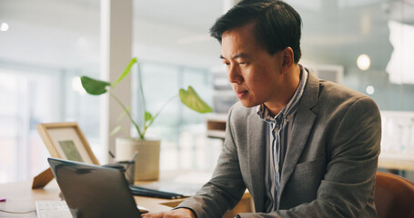 Man, reading and laptop in office for business, email draft or connection for feedback. Mature...