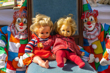 A variety of puppets on a flea market - baby dolls and clowns