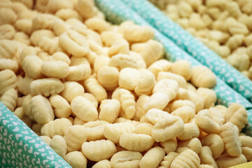 Fresh gnocchi on display at the Mercato Orientale in Genoa, showcasing traditional Italian pasta made with local ingredients