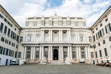Fototapeta premium Genoa, Italy - September 22, 2024: Majestic neoclassical facade of Palazzo Ducale with columns and statues dominates the historic city center.