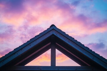 Rooftop triangle silhouette against a vibrant sunset sky.