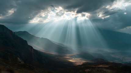 Ethereal light paints the mountain valley with radiant beams breaking through a cloudy sky