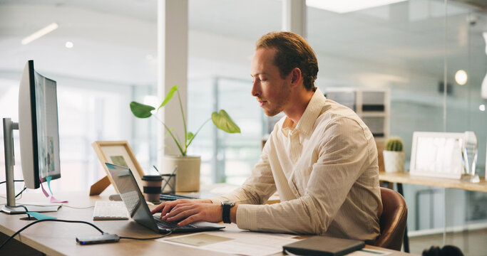 Man, typing and research on laptop for business, email draft or connectivity in office. Accountant, thinking and tech in workplace for tax compliance, networking or website for company income filing