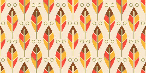 Repeating pattern of stylized leaves. Each leaf is divided into three sections of color: brown, yellow, and red.
