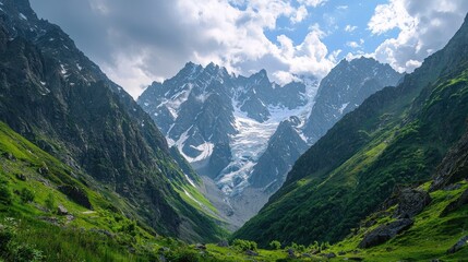 Majestic mountain valley with snow-capped peaks and lush greenery.