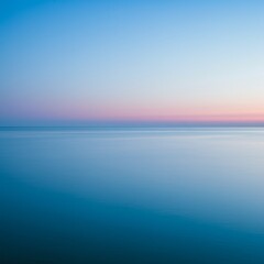 Obraz premium Serene Ocean Sunset: Pink And Blue Hues Over Calm Water
