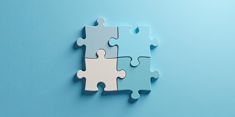 Obraz premium Four Interlocking Puzzle Pieces Representing Teamwork and Collaboration on a Light Blue Background