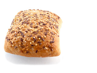 One small premium roll with seeds and grain on white background with reflection.