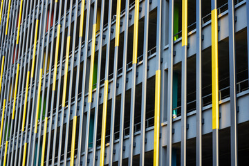 A tall building adorned with distinct yellow and blue stripes on its exterior