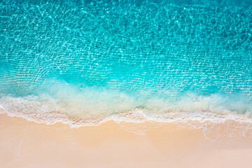 Stunning aerial top view summer sandy beach, pristine crystal clear sea water golden sand vibrant coastal vibes perfect for travel vacation nature photography. Calm waves, amazing landscape wallpaper