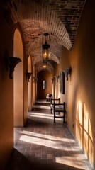 Warm light illuminates a hallway with arches and terracotta tiles.
