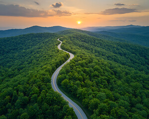Winding road sunset mountain aerial.