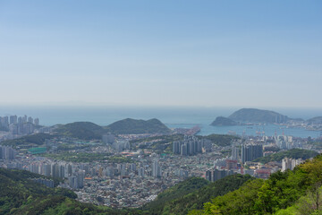 Panoramic cityscape photography, natural daylight colors, Busan skyline and harbor view, South Korea
