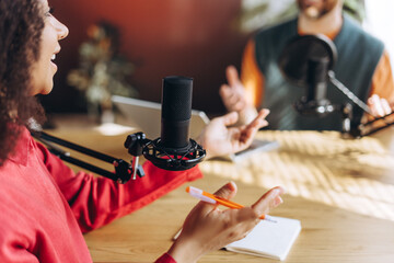 Two content creators recording a podcast in a studio