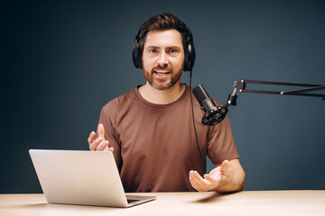 Content creator recording podcast using laptop and microphone