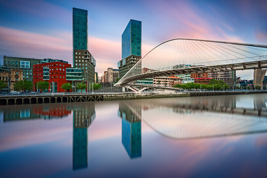 Waterfront cityscape with Zubizuri bridge across the Nervion, Bilbao, Vizcaya, Spain
