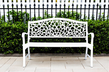 white metal bench with intricate in a setting