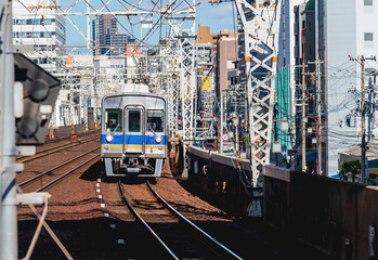 Local train arrive to railway station platform in Japan. Train transportation concept.