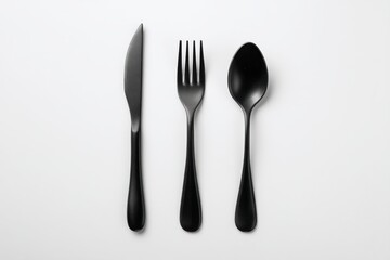 Elegant Black Cutlery: Knife, Fork, Spoon Set on White Background, Stylish Tableware for Modern Dining