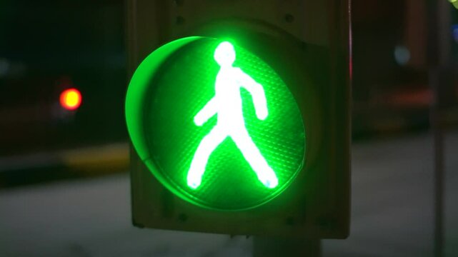 Close-up of a traffic light with a flashing green sign saying passing permitted.